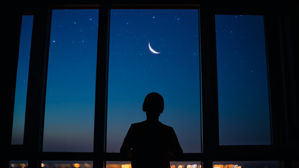 Persona contemplativa che osserva il cielo stellato dalla finestra, simbolo di resilienza emotiva e fiducia nel proprio percorso di benessere interiore
