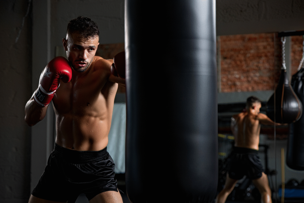 Pugile allena resilienza mentale colpendo sacco da boxe - psicologia sport e mental training per atleti